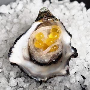 Oyster with Pickled Shallots and Passionfruit Flavour Pearls